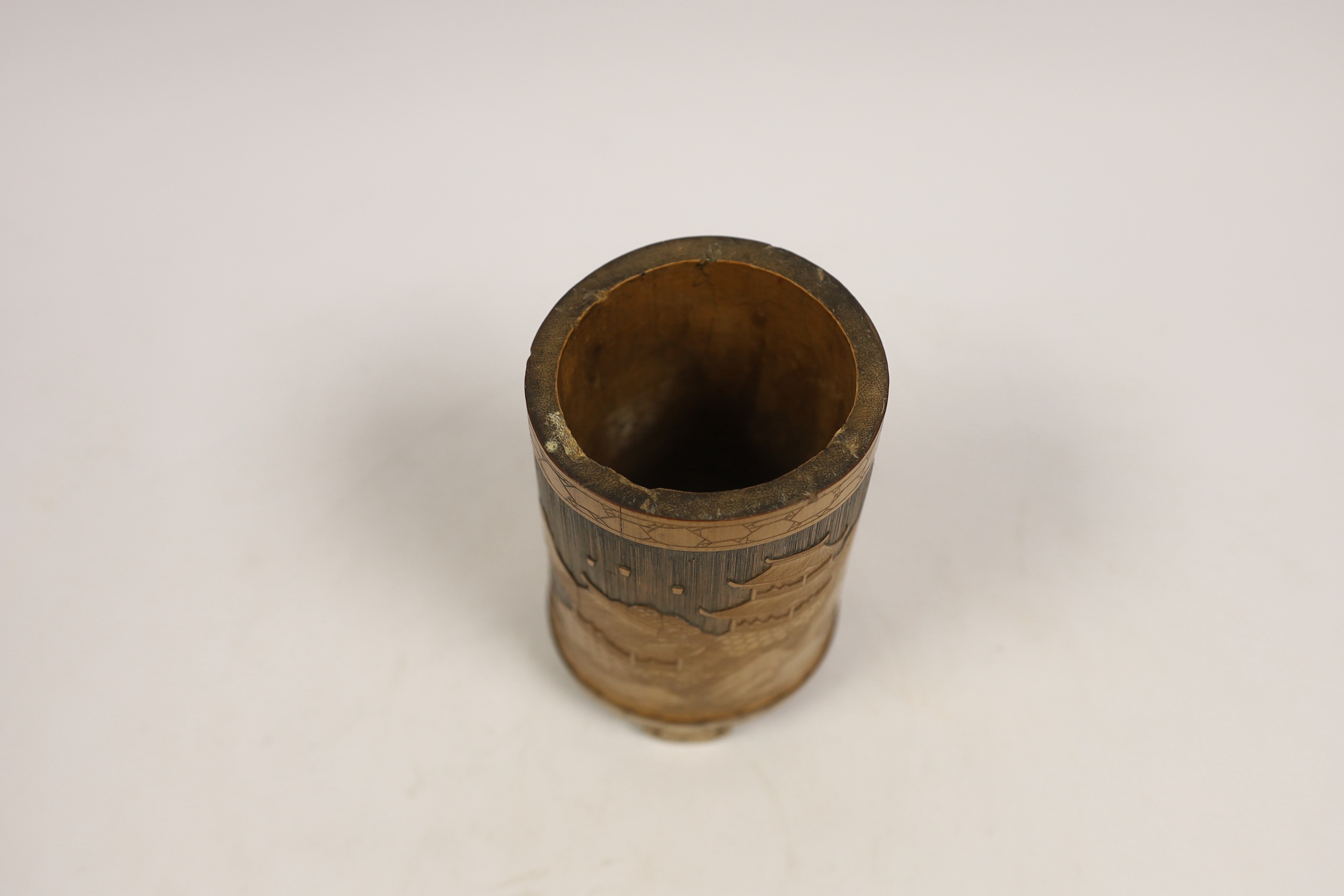 A Japanese bamboo brushpot carved with mountains and pagodas, 13cm high